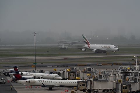 NEW YORK, NEW YORK - JUNE 9: A Qatar Airways plane lands as an Emirates plane taxis on the tarmac and Delta Air Lines planes sit at gates at John F. Kennedy International Airport on June 9, 2025 in New York City. A new travel ban ordered by U.S. President Donald Trump, restricting entry to citizens from 12 countries, will take effect on Monday. The affected nations include Afghanistan, Myanmar, Chad, the Republic of the Congo, Equatorial Guinea, Eritrea, Haiti, Iran, Libya, Somalia, Sudan, and Yemen. 
