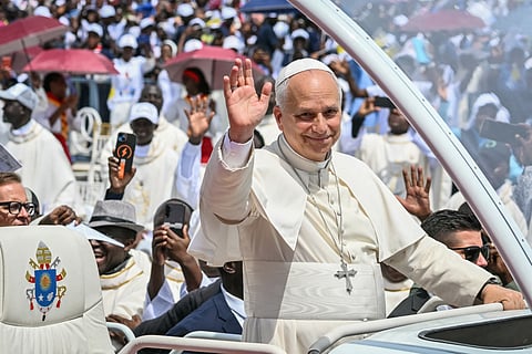 Pope Leo XIV waves to the crowd from the Popemobile as he arrives to lead the Holy Mass at the Saurimo esplanade in Saurimo on the eighth day of an 11-day apostolic journey to Africa, on April 20, 2026.