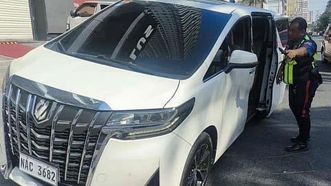 AUTHORITIES secure the white van that was flagged for using an unauthorized and improvised license plate, which led also to the arrest of two foreign nationals for allegedly bribing police officers who apprehended them.