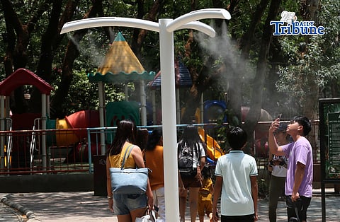 (April 22 2026) Families enjoy the newly installed outdoor misting system at the Quezon Memorial Circle in Quezon City on Wednesday, April 22, 2026. The misting areas, located within the park, offer instant cooling for visitors, joggers, and diners as part of city efforts to improve park comfort, to provide relief from intense summer heat.  Photo/Analy Labor