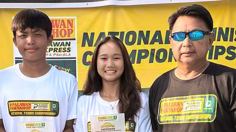 KATHLYN Bugna (center) shines with her trophy after another dominant run at the Capiztahan junior tennis. With her are fellow MVP Francisco De Juan III (left) and coach Ronald Martin.  