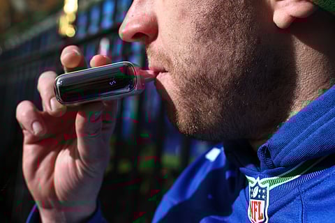 NEW YORK, NEW YORK - DECEMBER 02: A person uses a vape pen near Bryant Park on December 02, 2024 in New York City. The Supreme Court began to hear arguments on the Food and Drug Administration, refusal to approve flavored e-cigarettes over public health concerns. 
