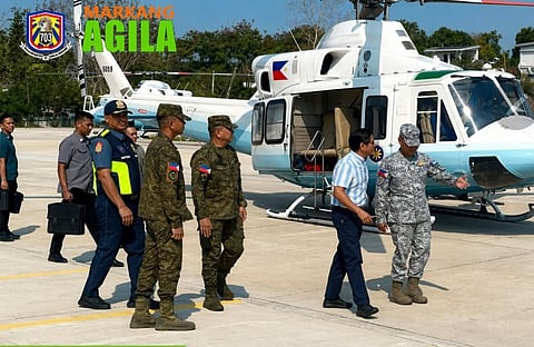 Troops from the 703rd Brigade welcome President Marcos during his visit to Palayan City Township on 23 April.