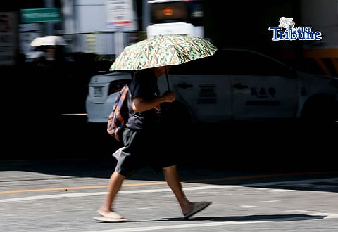 (April 24 2026) In Quezon City on Friday, April 24 2026, a pedestrian used an umbrella to protect herself from the heat of the sun,  According to the PAGASA Metro Manila today face "extreme caution" to danger of heat index level (37°C–39°C). Photo/Analy Labor