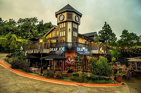 DEAR Joe café stands amid towering pine trees in Crosswinds Tagaytay, offering visitors a quiet retreat in a European-inspired setting.
