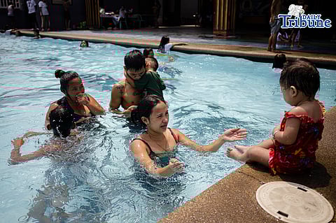 Tondo residents take advantage of the free swimming pool program amid extreme heat