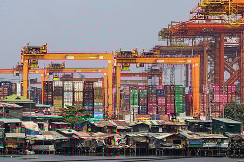 Informal settlements line the edge of the container port area in Manila, as seen from a pedestrian overpass along Mel Lopez Boulevard. A recent study by the government think tank Philippine Institute for Development Studies warns that the current oil crisis could push over 1.3 million more Filipinos into poverty as rising fuel costs lead to an immediate spike in the cost of rice, fish, meat, and vegetables.
