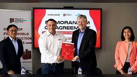 MARKUS Hennig (second from left), executive vice president of Megawide Construction Corporation, and Christopher Zimmer (second from right), executive director of German-Philippine Chamber of Commerce and Industry, present the signed agreement for a dual training program for precast concrete constructors during the launch event in Makati City.