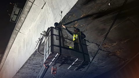 DEPARTMENT of Public Works and Highways crews and structural engineers inspect the EDSA-Ortigas Flyover southbound and the EDSA-Ortigas Interchange on Saturday following a bus fire at the site on Friday.