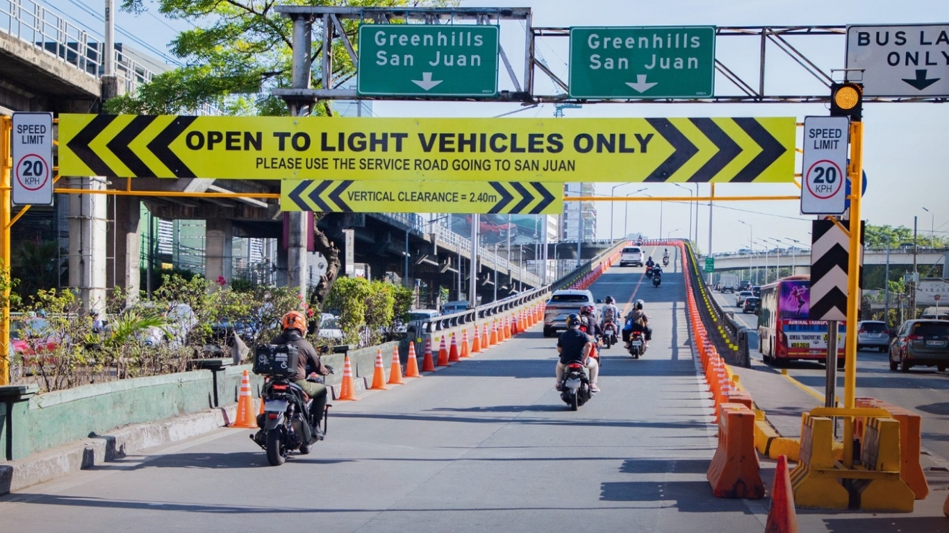 LIGHT vehicles traverse the EDSA-Ortigas Interchange on Monday following its partial reopening by the Metropolitan Manila Development Authority. The flyover was restricted to light traffic only to allow for structural inspections and repairs after a bus fire damaged the structure.