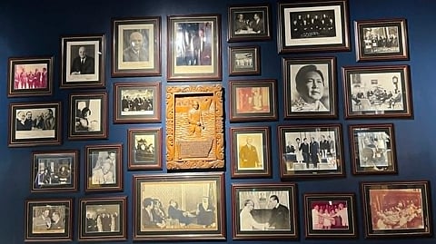A WALL of photographs chronicles Romulo’s key moments.