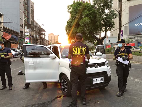 Police SOCO (Scenes of Crime Officer) conducting an investigation over shooting incident happened Tuesday afternoon at Timog Avenue corner EDSA, Barangay South Triangle, Quezon City. (Photo captured by Sean Magbanua, 5:50PM)