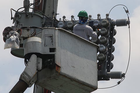 Powered  Meralco technician installs new electricity meters in Tondo, Manila, threading households into the city’s restless current.