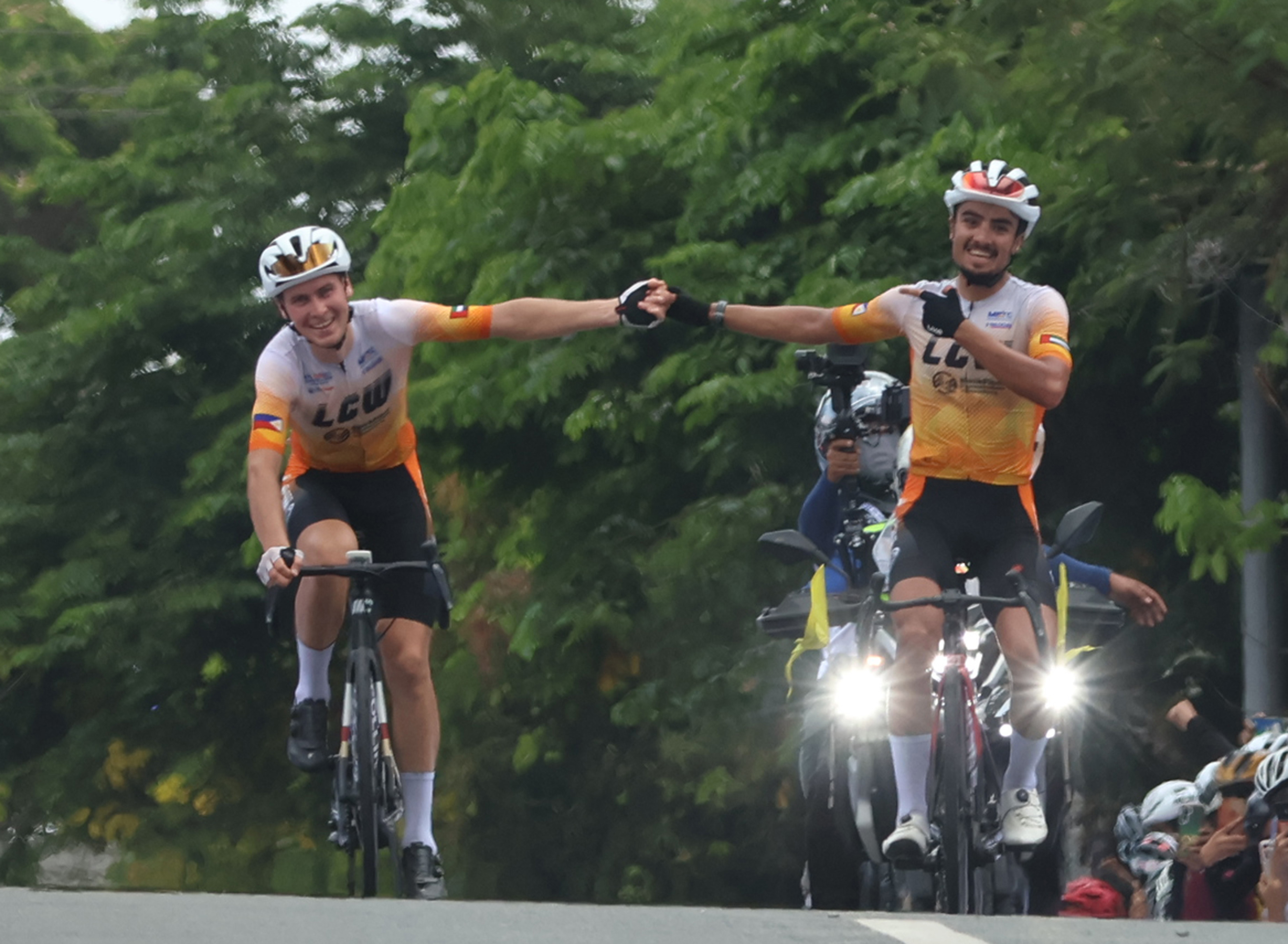 Yousef Ibraheim Alrefai and Nikita Shulchenko of LCW UAE Cycling Team celebrate after crossing the finish line at the Praying Hands Monument in Tagaytay City during the opening lap of the MPTC Tour of Luzon on Wednesday.