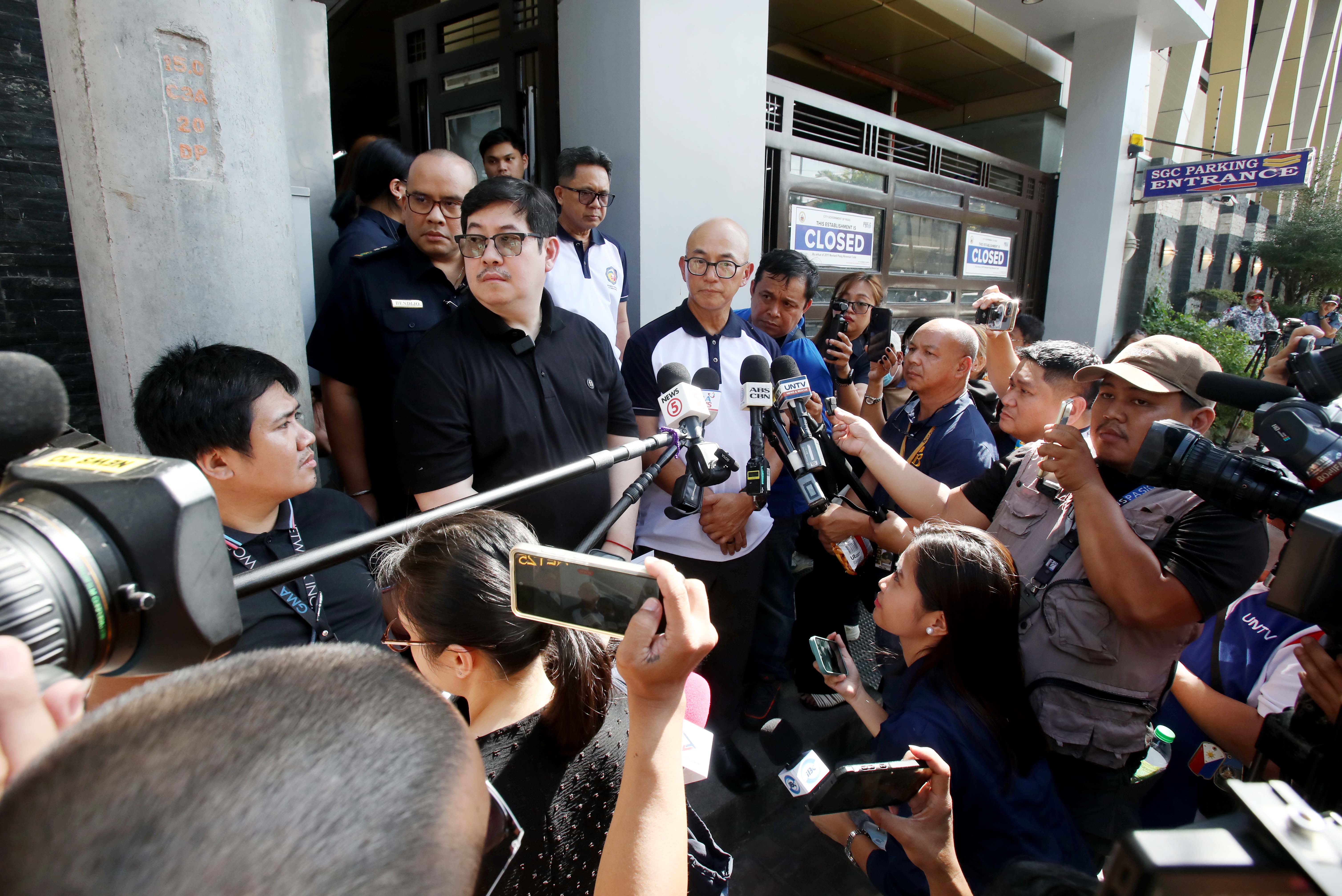 CUSTOMS Assistant Commissioner Vincent Philip Maronilla and Bureau of Internal Revenue Assistant Commissioner for Enforcement and Advocacy James Roldan speak to the media outside the St. Gerrard Construction office in Pasig City on Wednesday, as authorities implement administrative measures to secure vehicles linked to the Discaya couple in ongoing tax cases. Media were not allowed inside the premises upon the request of the couple’s legal counsel.