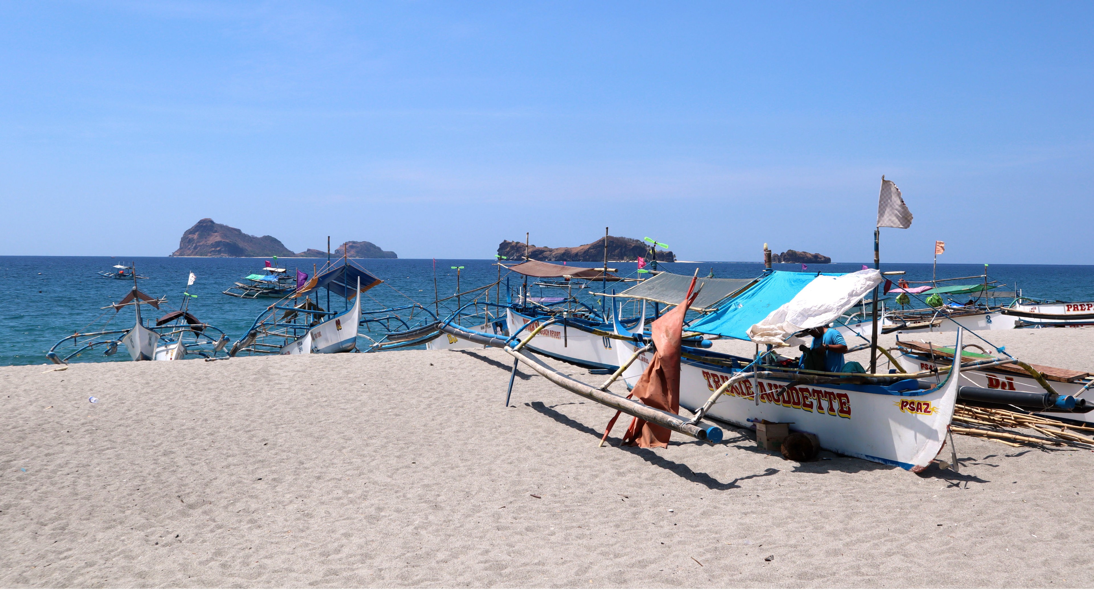Fishing boats that are also used to ferry tourists to islands are seen at the coastal area of San Antonio, Zambales.