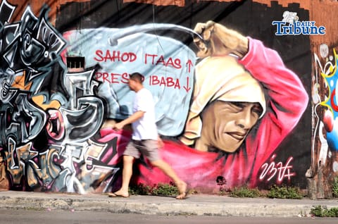 (May 01 2026) A mural portraying workers’ struggles and urging higher wages and lower prices of basic commodities seen along Himlayan road in Quezon City on Friday, May 1, 2026. An Artist tribute to the workers during  Labor Day Celebrations. Photo/Analy Labor