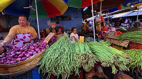 VENDORS arrange their wares at a Manila market on Labor Day, unable to afford the luxury of rest in an economy that keeps raising its price tag on everyday life.