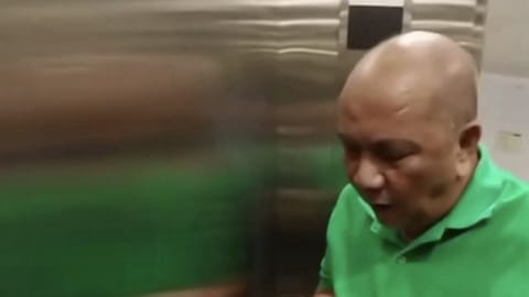 Jay Sonza sniffing nebulizer during his turnover at the National Bureau of Investigation. 