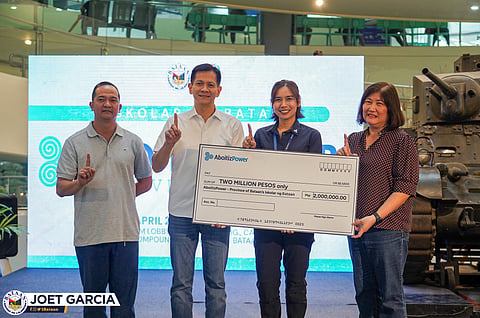 Governor Joet Garcia and Vice Governor Cris Garcia receive the ceremonial check from AboitizPower Vice President for Corporate Services Andrea Madrid, with Iskolar ng Bataan coordinator Ramon Cañas witnessing the turnover.