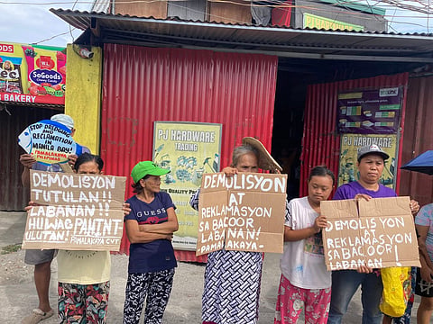 Bacoor fishers and coastal residents take to the streets to oppose the planned demolition of over 100 homes in Barangay Talaba II, saying the move threatens their livelihood as a reclamation project looms. Members of PAMALAKAYA assert they will defend their community despite relocation plans far from the sea.