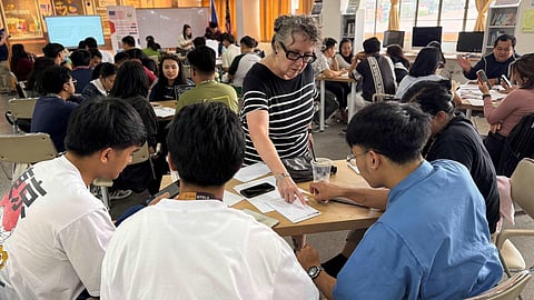 AN AMERICAN English Language Fellow guides college instructors in effectively teaching complex subjects in English during a professional development session.