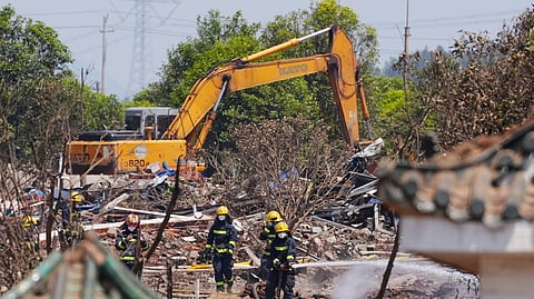 FIREFIGHTERS spray water at the scene of a fireworks factory explosion in Liuyang, in China’s central Hunan province. The death toll from a giant explosion at a fireworks factory in central China rose to 26, with 61 more injured, officials said.