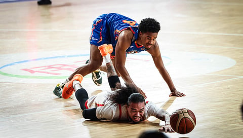JOSHUA Munzon of Titan Ultra and Schonny Winston of NLEX chase the loose ball during their PBA Commissioner’s Cup game last night at the Ninoy Aquino Stadium. The Road Warriors prevailed, 123-112.