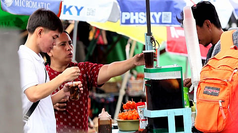 CUSTOMERS buy juice for refreshment along Commonwealth Avenue. Residents are finding ways to stay cool as the heat index reaches dangerous levels across Metro Manila.
