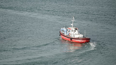 CREW members wearing hazmat suites leave the port on an ambulance boat towards the cruise ship MV Hondius, while stationary off the port of Praia, the capital of Cape Verde, on 6 May 2026.