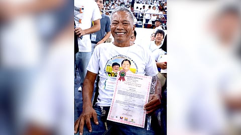 Rodolfo Regis, a 63-years old agrarian reform beneficiary (ARB) from Palo, Leyte shows off his COCROM that condoned his P659,160.49 debt to Land Bank.