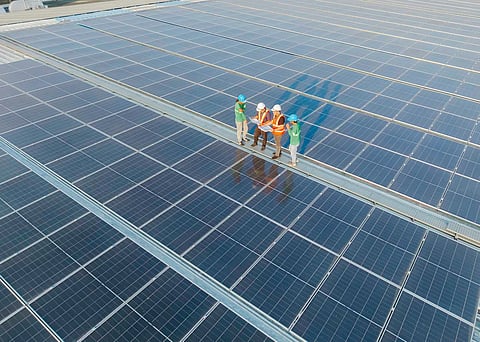 ENGINEERS and workers inspect rooftop solar panels installed at an SM Supermalls facility as part of the company’s energy efficiency and sustainability initiatives.