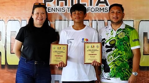 FRANCISCO de Juan III displays his plaques after dominating the boys' U14 division of the Philta Age Group Championships at the San Carlos Tennis Center in Negros Occidental on Sunday.