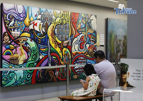 (May 12 2026) A little girl accompanied by a man enjoyed viewing the large painting exhibit detailing Philippine history on Tuesday may 12 2026, at the art museum of Araneta City, in Quezon City. It is a popular, free-admission cultural hub focused on Philippine history and art. Photo/Analy Labor
