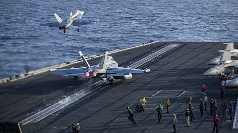AN F/A-18E Super Hornet and an EA-18G Growler launch from the flight deck of aircraft carrier USS Abraham Lincoln on 9 May 2026. 