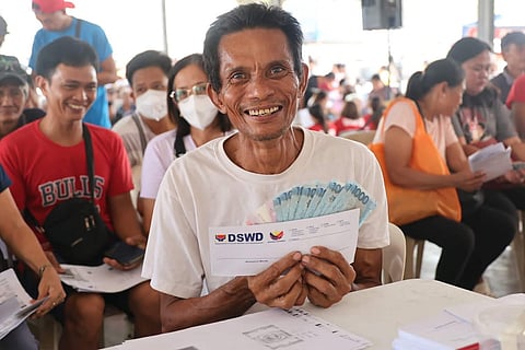 RESIDENTS near Mayon Volcano in Albay province are all smiles as they receive the cash assistance provided by the Department of Social Welfare and Development.
