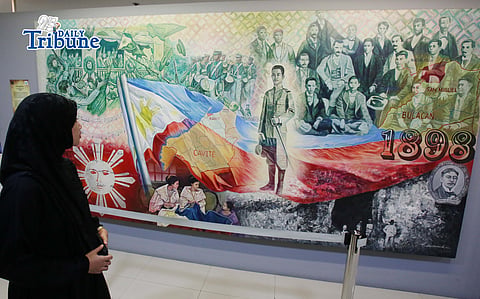 (May 15 2026)  Weeks before the National Flag Day celebration on May 28, a Muslimah looked at the large painting depicting the 1898 Declaration of Philippine Independence from Spain. displayed at the SiningSaysay; Philippine History in Art Exhibit at the Gateway in Araneta City, on Tuesday May 12 2026. It is dedicated to showcasing Filipino history through visual arts and promoting local culture. Photo/Analy Labor