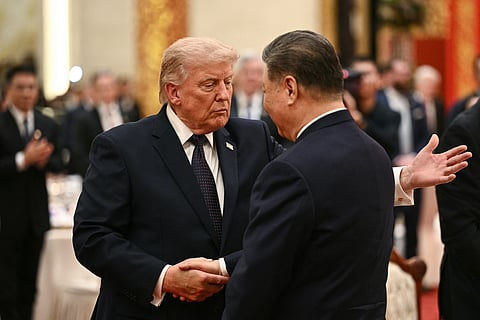 CHINA’S President Xi Jinping (right) and United States President Donald Trump shake hands as they attend a state banquet at the Great Hall of the People in Beijing on 14 May 2026.