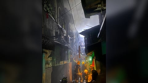 FIRE investigators inspect the damage after a deadly blaze hit New Barrio, Caloocan City, late Thursday night. Bureau of Fire Protection personnel arrived at the scene in Barangay 145 shortly after the fire broke out at 10 p.m., but reported one fatality — a 50-year-old bedridden woman.