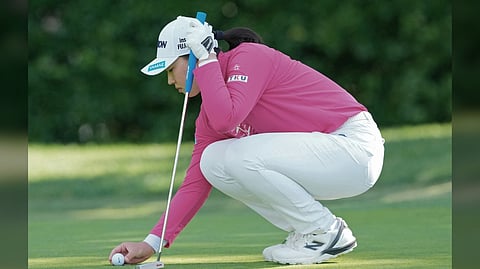 JAPAN’S Rio Takeda studies her line on the sixth green during the opening round of the Kroger Queen City Championship presented by P&G at Maketewah Country Club in Ohio.