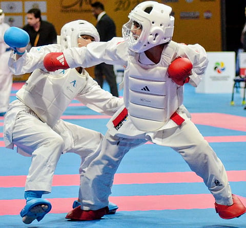 FRANCIS Earl Abundo (right) bruises his way to the under 14 male kumite -40 kg class on the final day of the Karate One Youth League at the Mall of Asia Arena.
