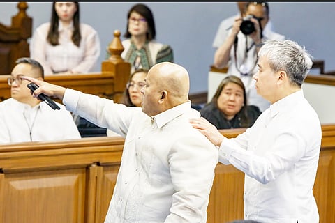 SENATOR Ronald dela Rosa is calmed by colleague Joel Villanueva amid a charged confrontation.