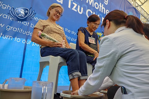 DR. Gina Ang washes the feet of retina patient Sherly Jaro. 