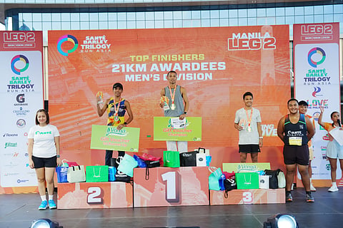 DICKIYAS Mendioro, Ritchie Estampador and Edsel Moral celebrate on top of the podium after emerging victorious in the 21K division of the Sante Barley Trilogy Run Asia 2026 Manila Leg 2 on Sunday at the SM Mall of Asia Complex.