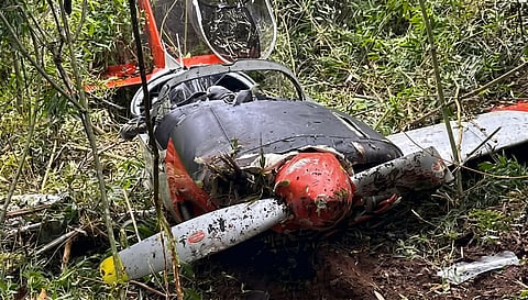 EMERGENCY responders secure the wreckage of a Philippine Air Force aircraft after it crashed into Mt. Sto. Tomas in Sitio Cabuyao, Barangay Poblacion, Tuba, Benguet, on Wednesday morning.