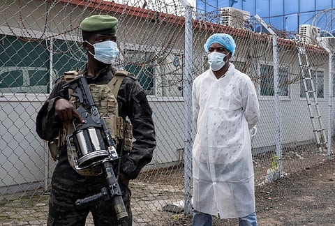 A MEMBER (left) of the M23 rebel group stands guard as provincial authorities visit the Rodolphe Merieux Laboratory, National Biomedical Research Institute, where samples from suspected Ebola cases are tested, as part of the response to the epidemic in Goma, North Kivu province of the Democratic Republic of Congo, 19 May 2026.