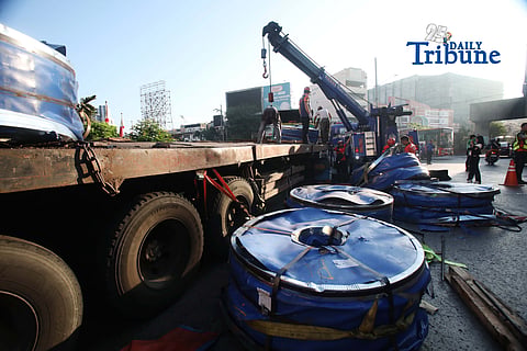 Metropolitan Manila Development Authority personnel respond to a 22-wheeler truck carrying heavy steel coils after it tilted at Bonifacio Monument Circle in Caloocan City on Thursday, 21 May 2026.

Authorities said the truck lost balance while navigating the roundabout. The vehicle came from North Harbor in Manila and was headed to Balagtas when the incident occurred. Photo by Analy Labor.