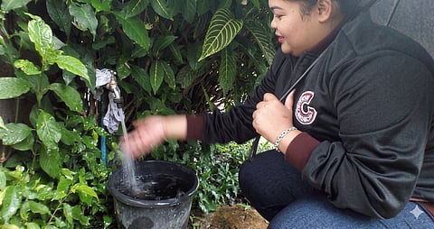 A resident carefully uses a bucket to collect water for washing dishes, a simple but telling act of daily water conservation. In communities where every drop matters, even routine household chores become a quiet struggle to stretch limited supply and make ends meet.