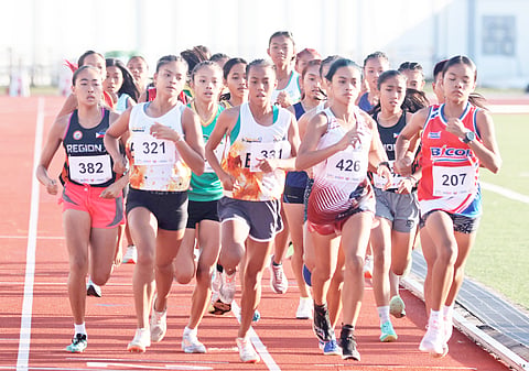 CHRISIA Mae Tajarros of Eastern Visayas (center) leads the way en route to winning her second straight gold medal in the girls 3000m of the Palarong Pambansa on Monday in Agusan del Sur. 