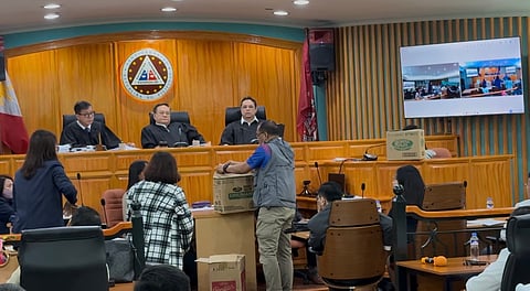 Allen Torrecampo, an aide of SYMS Construction owner Sally Santos, brought groceries boxes to the Sandiganbayan Third Division where she was called to testify in the malversation trial of former DPWH Engr. Brice Hernandez, former senator Ramon "Bong" Revilla, and other officials on Tuesday, 26 May.